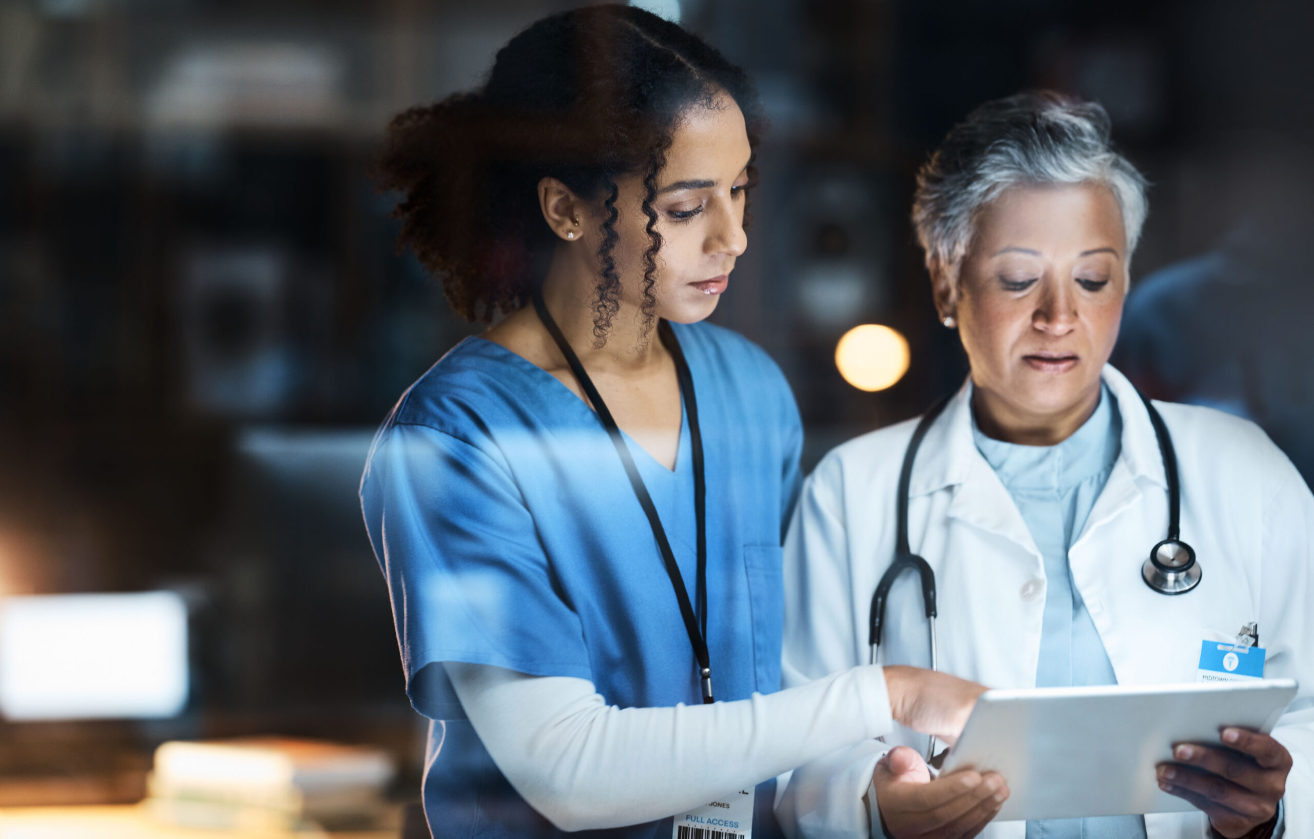 Image of doctors reviewing information on tablet