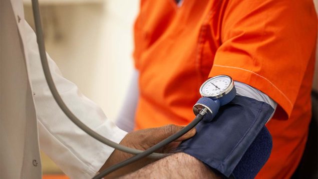 The figure is a photo of a health care provider checking a person&rsquo;s blood pressure.