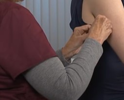 Nurse gives a patient a bandage after subcutaneous injection on the back of the arm