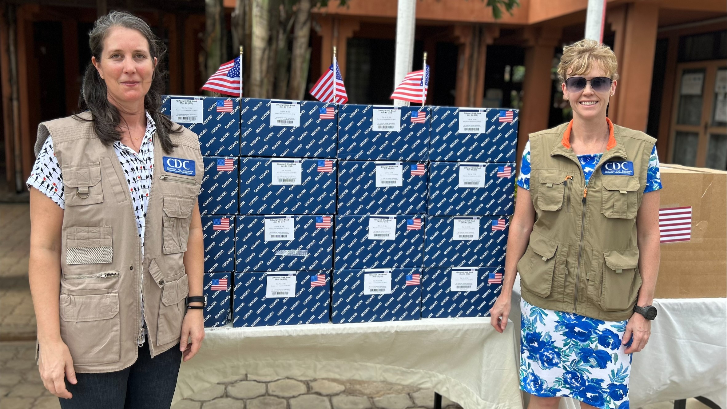 CDC staff stand with donated laboratory supplies