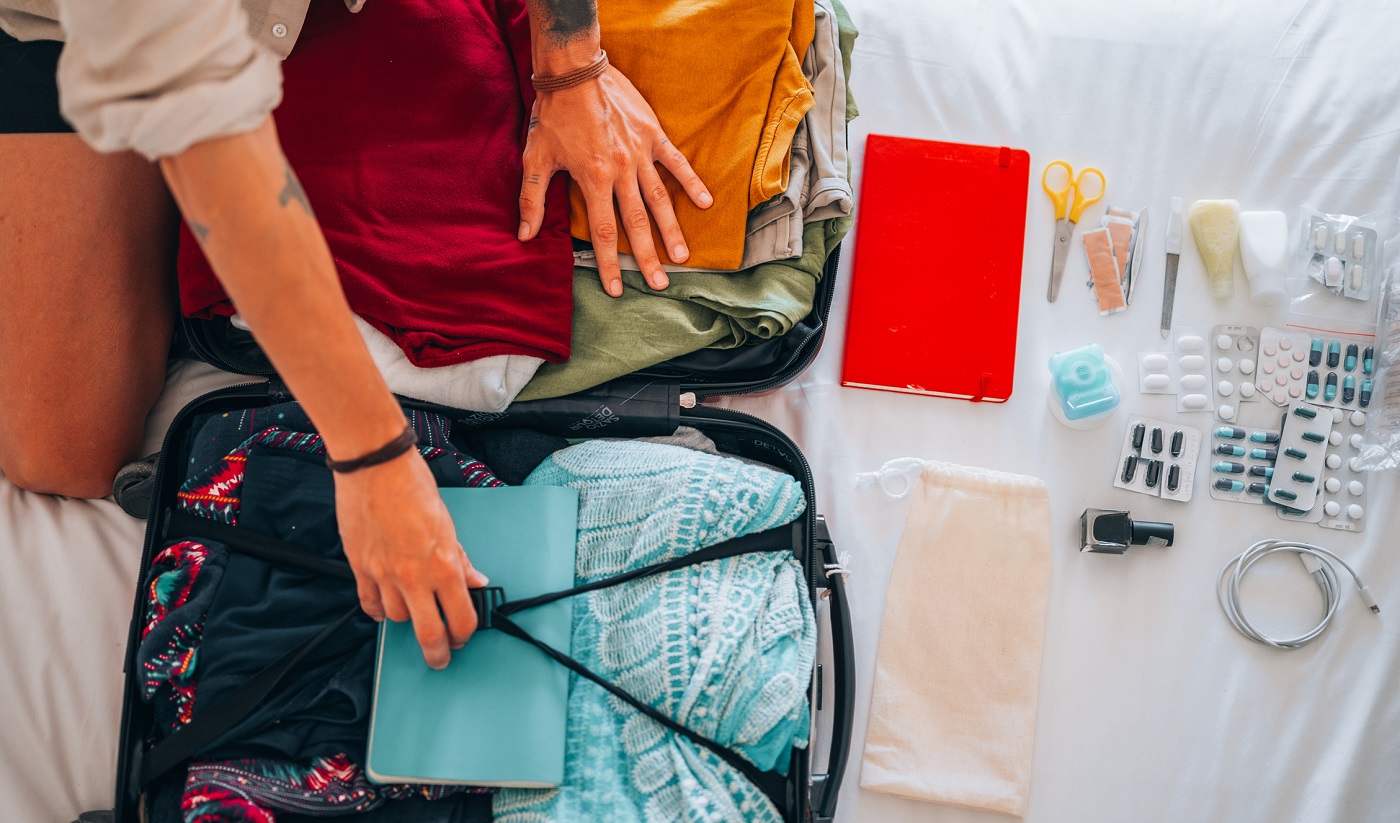 A person packs a suitcase before traveling