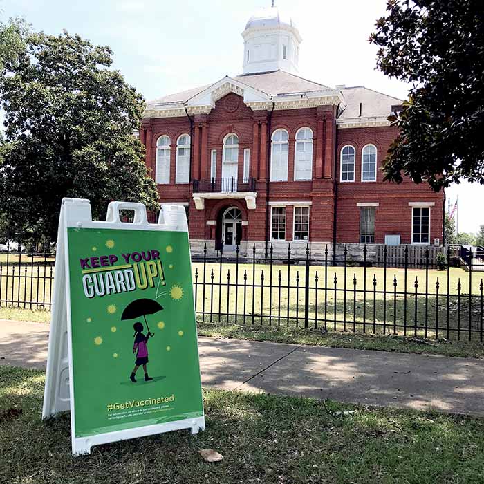 photograph of &ldquo;Keep Your Guard Up&rdquo; sign on sandwich board outside of courthouse in Sumpter County