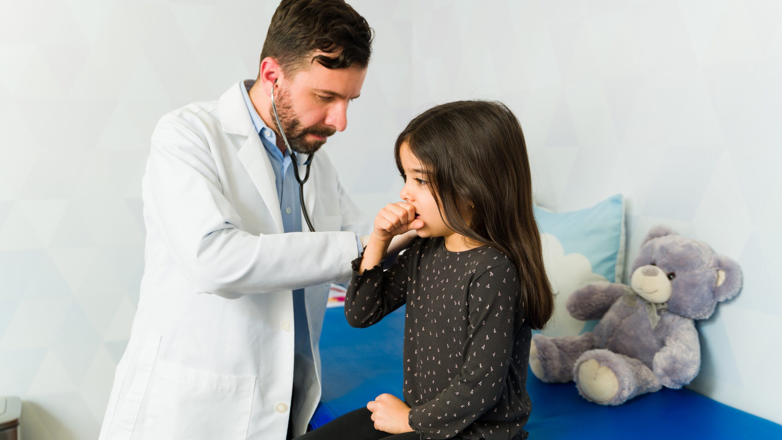 Doctor examines coughing child