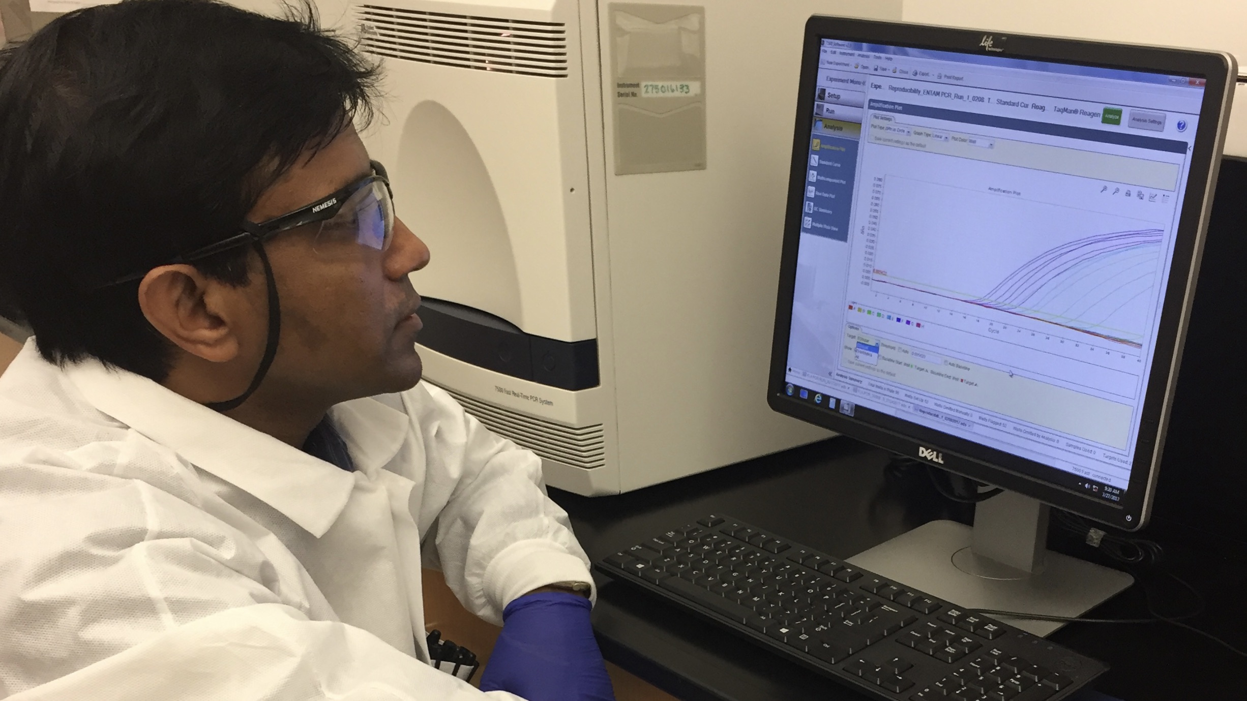 CDC scientist Shantanu Roy sits in front of computer and runs a test on a suspected infection caused by Naegleria fowleri.