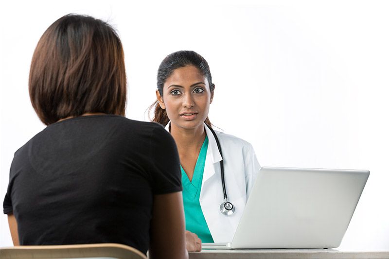 A family discusses their child with a doctor.