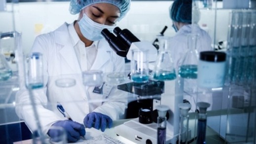 Scientist looking at a microscope
