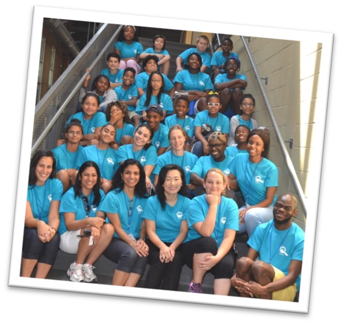 2017 camp group photo showing 30+ campers and staff in matching aqua shirts.