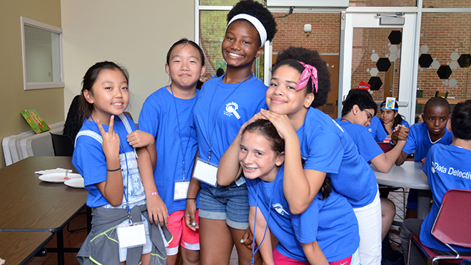 5 campers posing with their newfound friends.