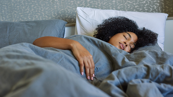 A woman sleeping in her bed.