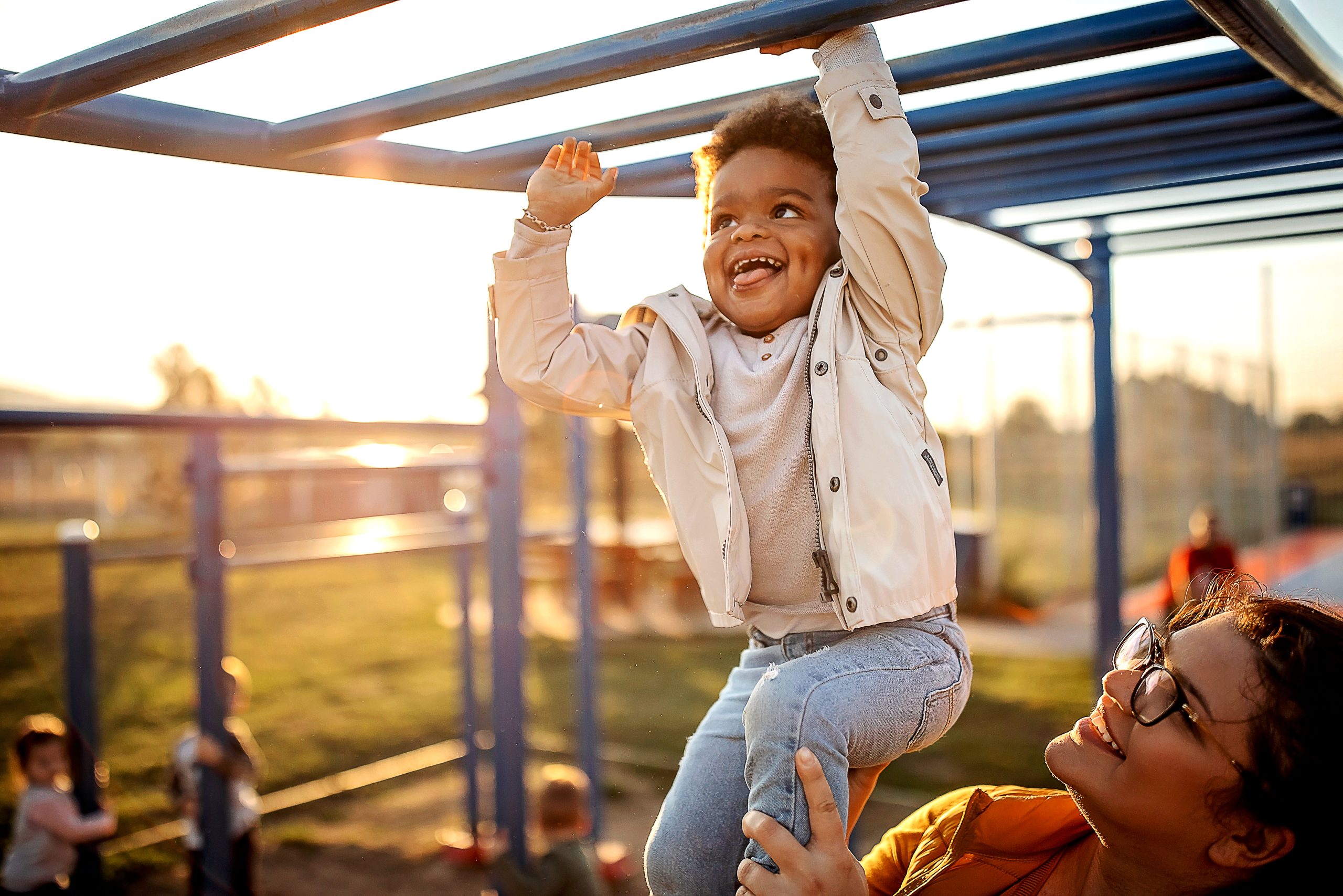 Happy child and mom Decorative: Happy child plays on playground with mom