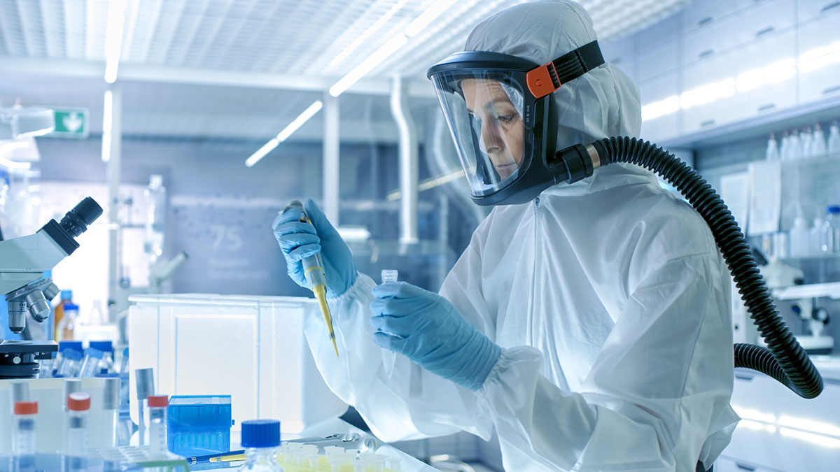 A laboratory worker wearing a full facepiece respirator.