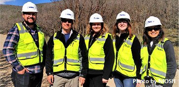 Rotator and program staff in hard hats and safety vests