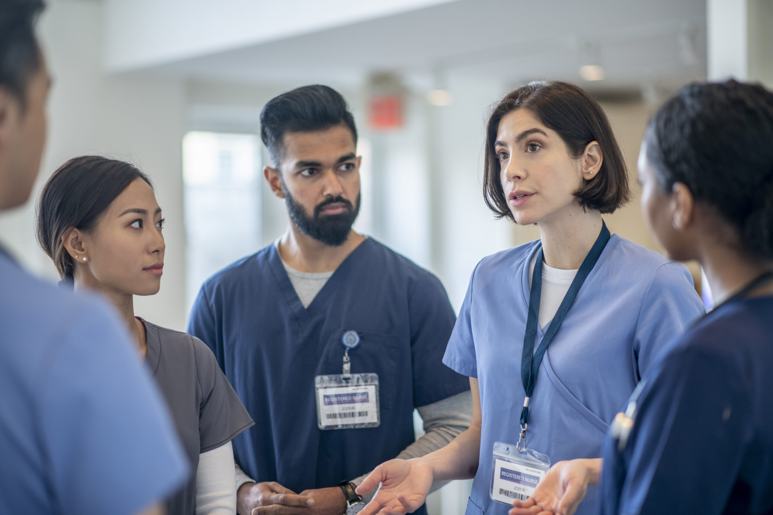 Five health care workers in discussion