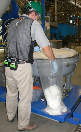 Worker wearing NIOSH sampling equipment.