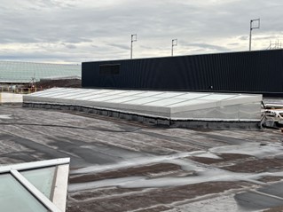 Much of this roof was prefabricated off site and lifted into place and skylights in the roof followed an international design standard using shatterproof glass to eliminate fall hazards.
