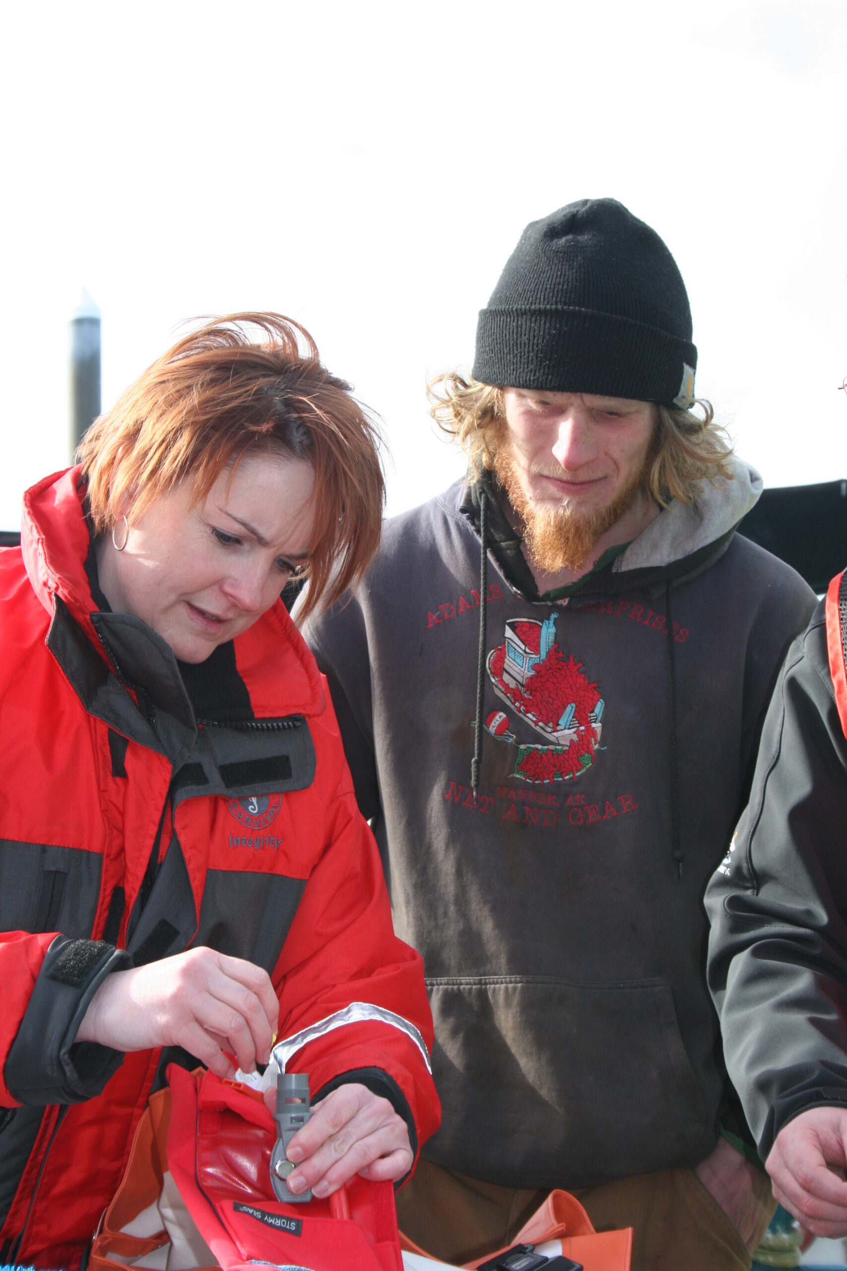 Jennifer Lincoln going over PFD maintenance with a longline fisherman.