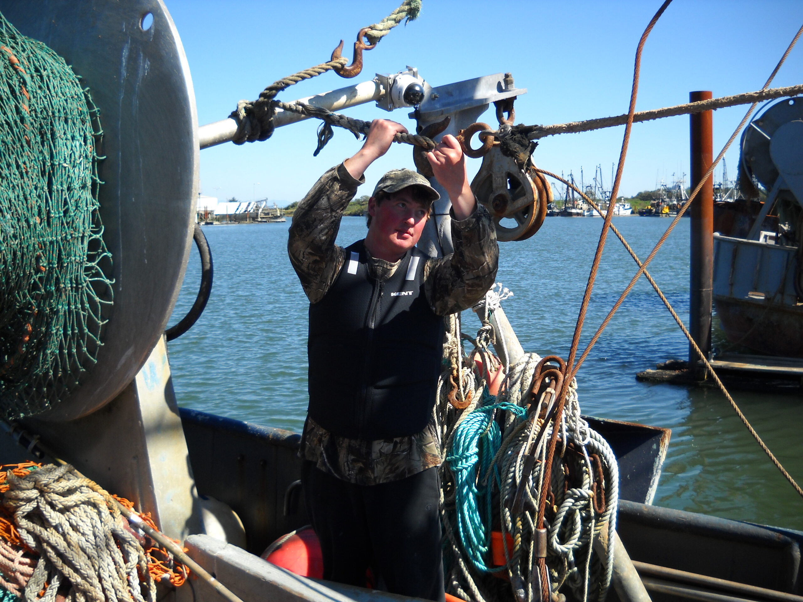 12-year commercial fishing veteran Brett Smith works the line while wearing a flotation vest.
