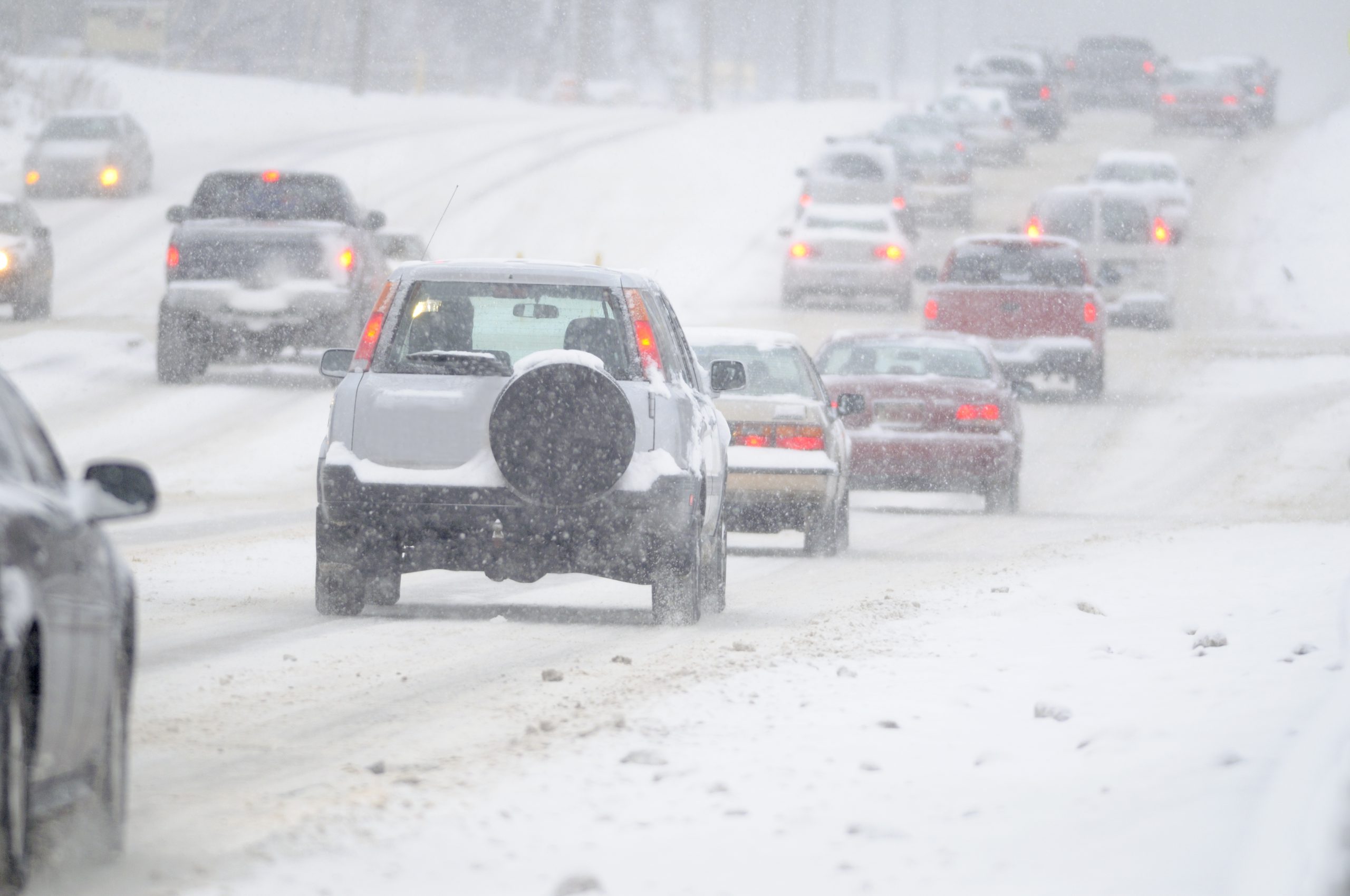 cars driving in snowy conditions