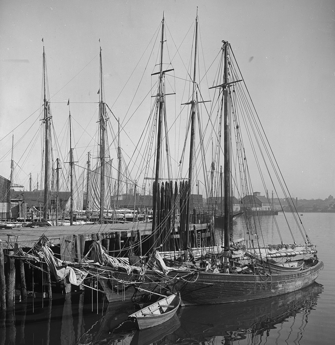Photo by Library of Congress A schooner is docked at a Gloucester port in 1900. The top-heavy vessels brought danger to the fishing profession.