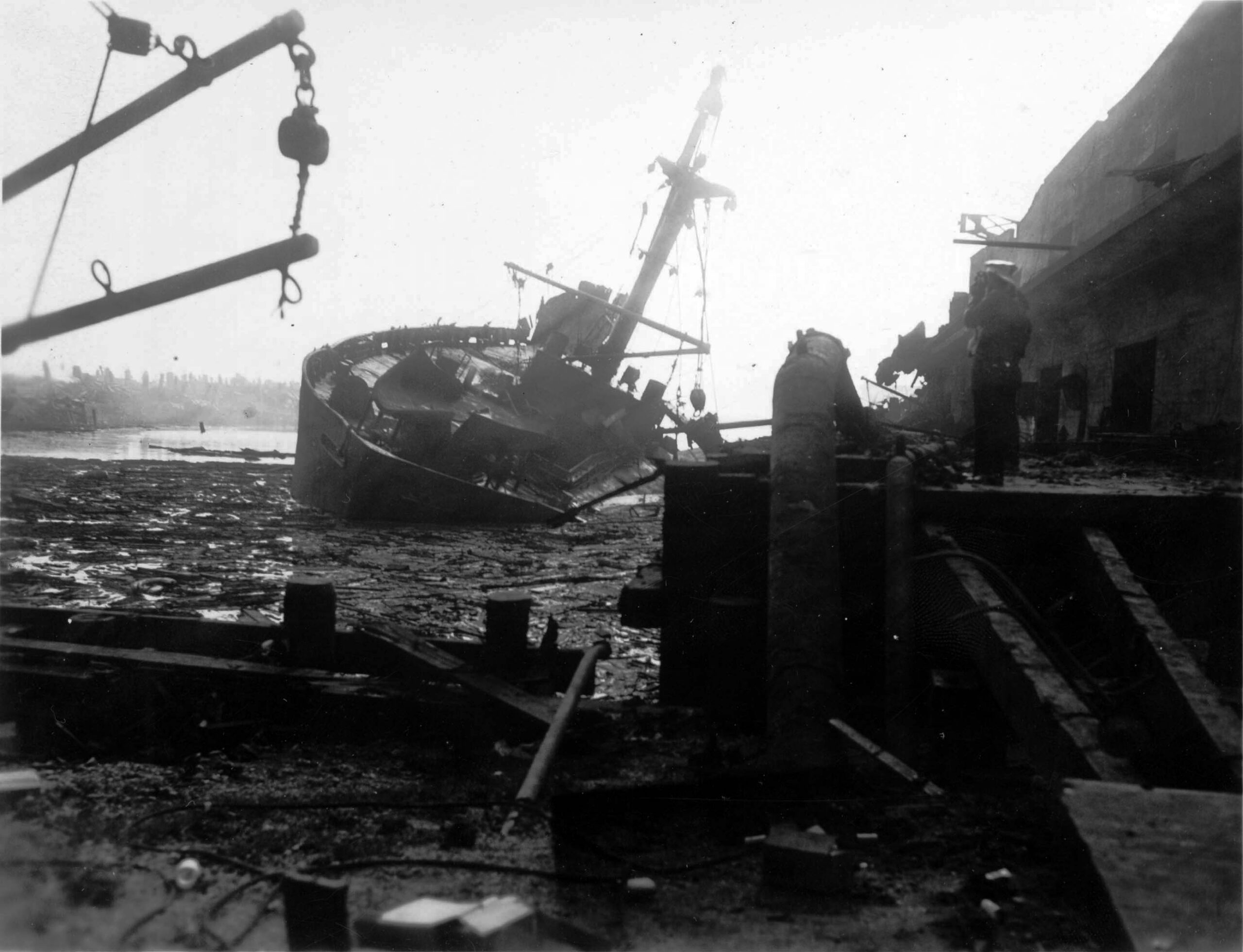 Photo by Library of Congress A damaged ship lists amid the blast devastation at the 1947 Texas City naval yard scene.