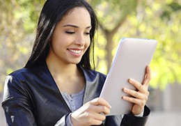 Photo of woman reading on a tablet.
