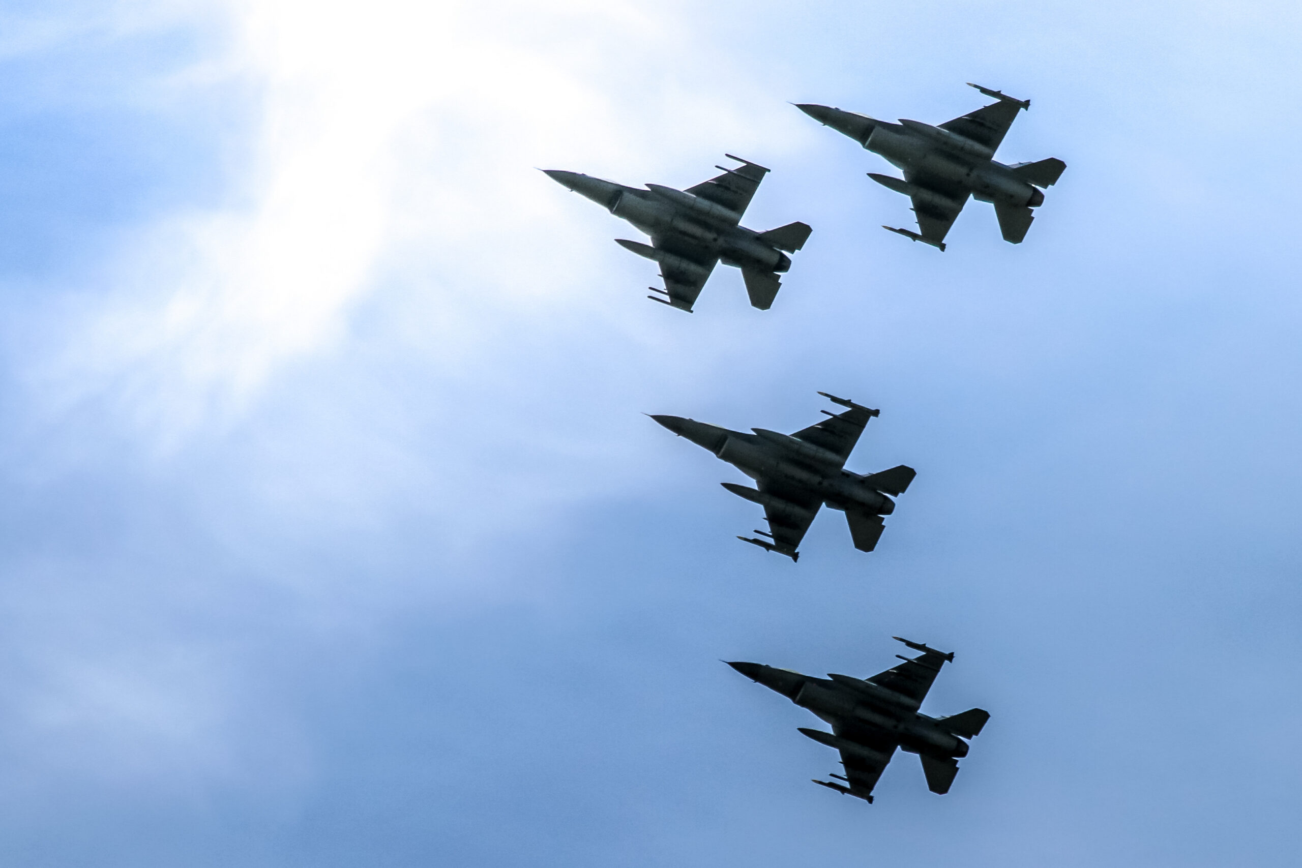 photo of four fighters jets in the air