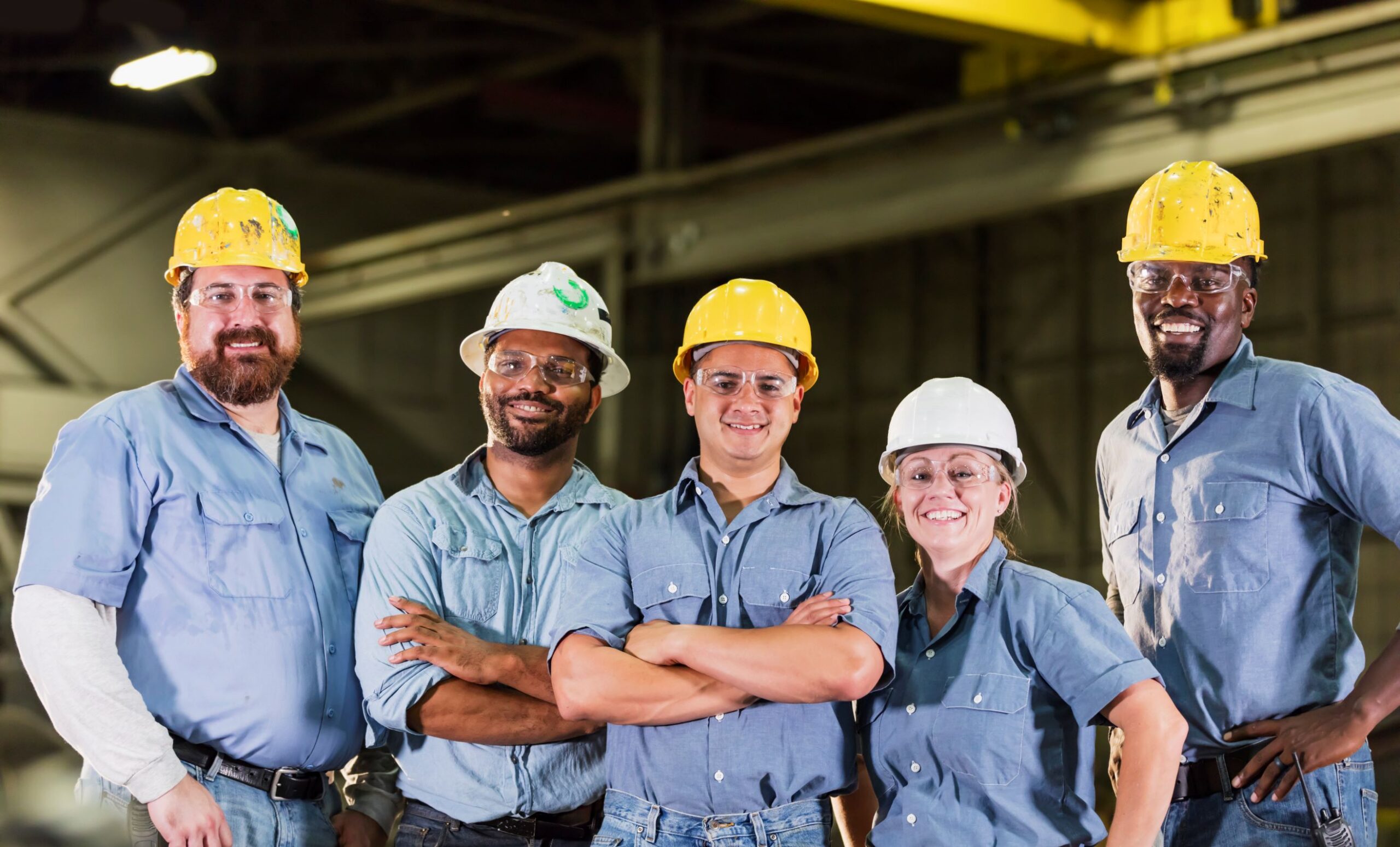 photo of five workers wearing safety glasses
