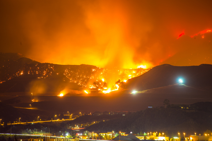 Image of large fire burning in California at night.