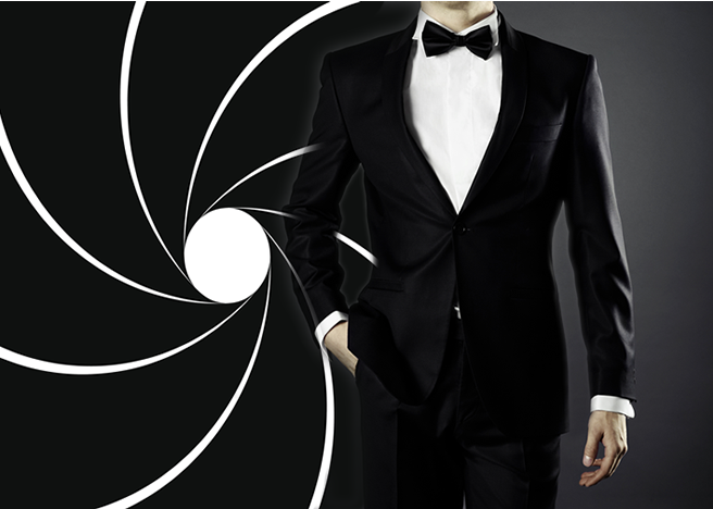 cropped midsection of a man in a suit and bowtie with one hand in his pocket, James Bond imagery