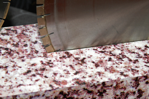 stone countertop with a blade cutting through it