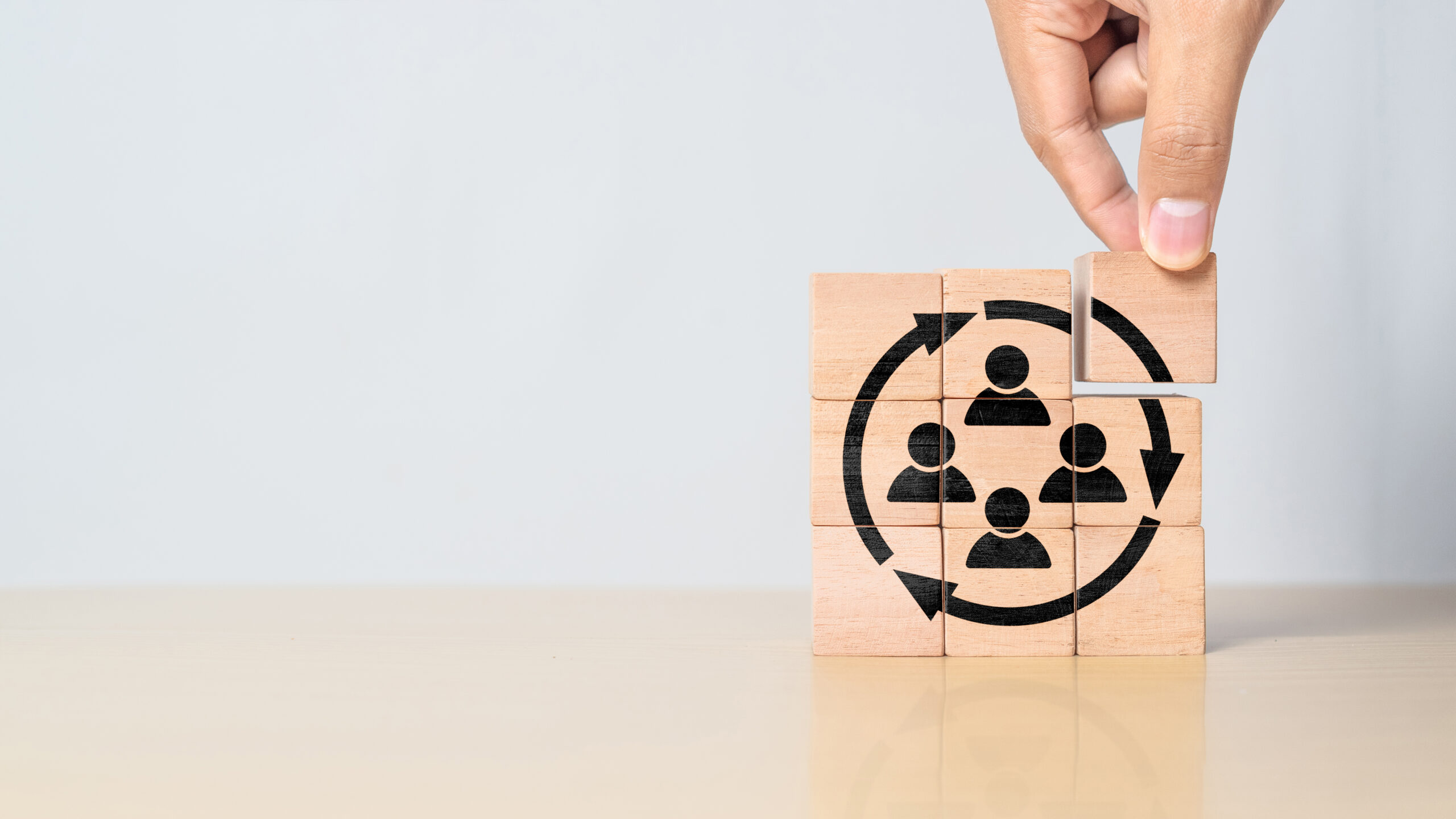 Wooden blocks with staff icons and arrows