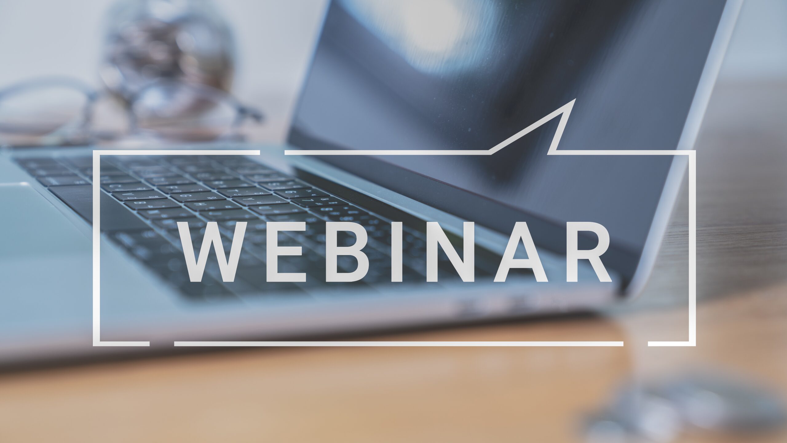 Laptop with text overlay saying "webinar"