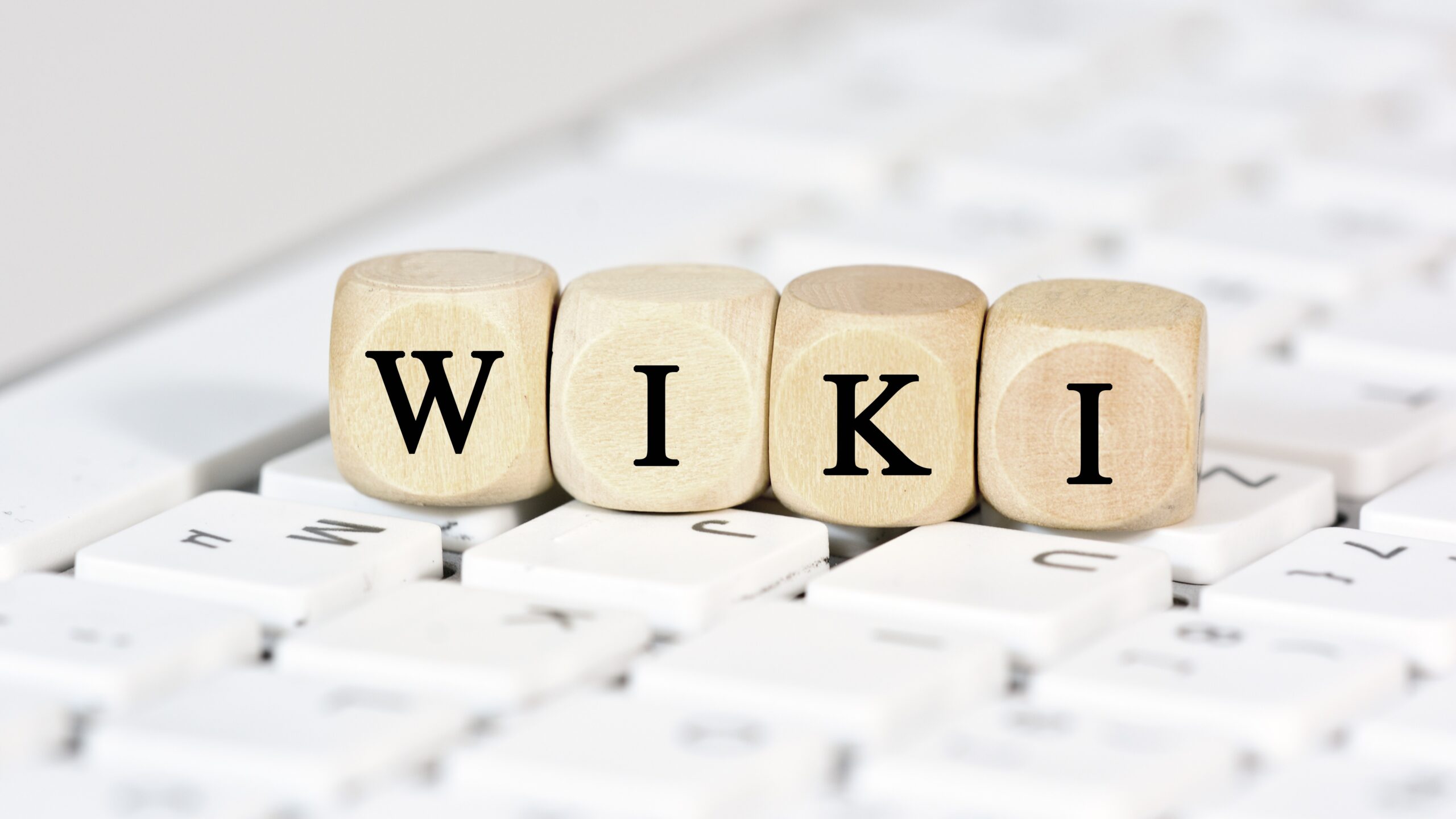 three wooden blocks with letters printed on them that spell "wiki"