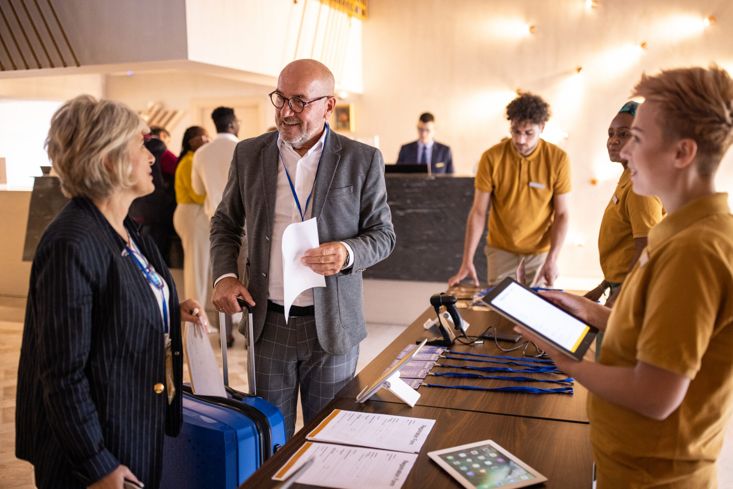 Two professionals standing at a conference check in desk