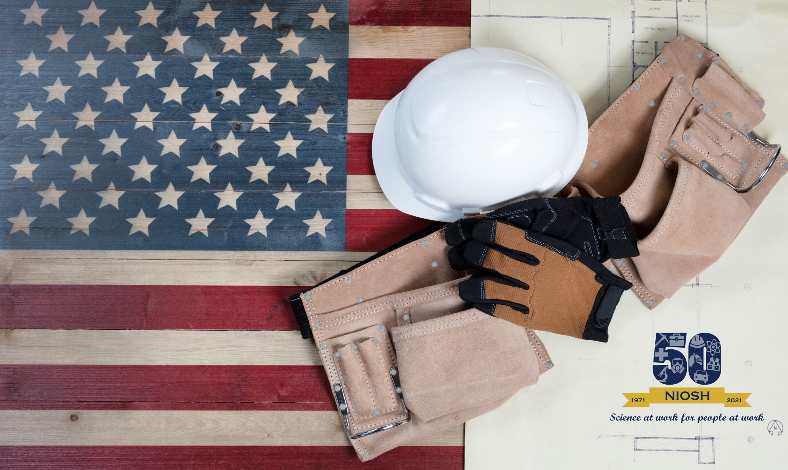 image of flag and construction helmet, belt, and gloves