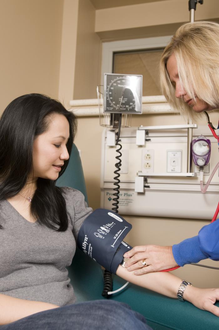 image of woman having her blood pressure taken.