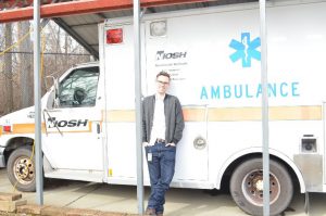 man standing by an ambulance.
