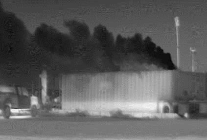 grainy black and white photo showing a mist above a building