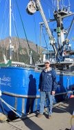 Devin Lucas in front of a boat.