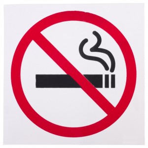 Image of lit cigarette with red circle around it and red line through it.