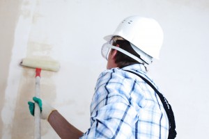 Person painting a wall