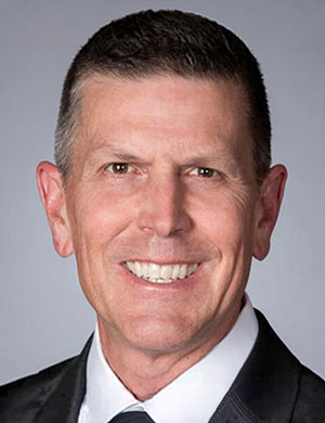 Image of Bruce Lyon, a caucasian male in black suit.