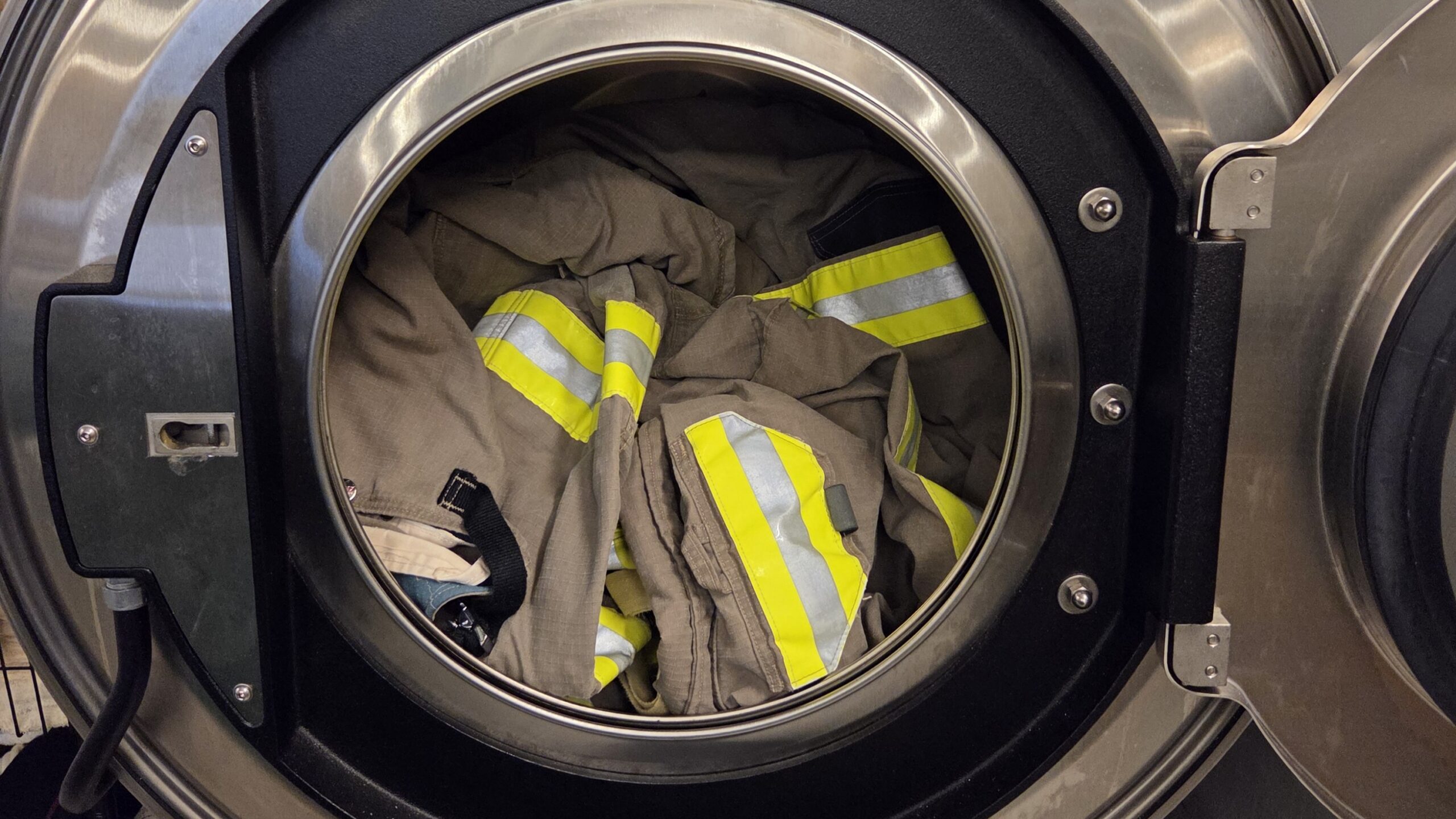 photo of firefighter gear in laundry machine.