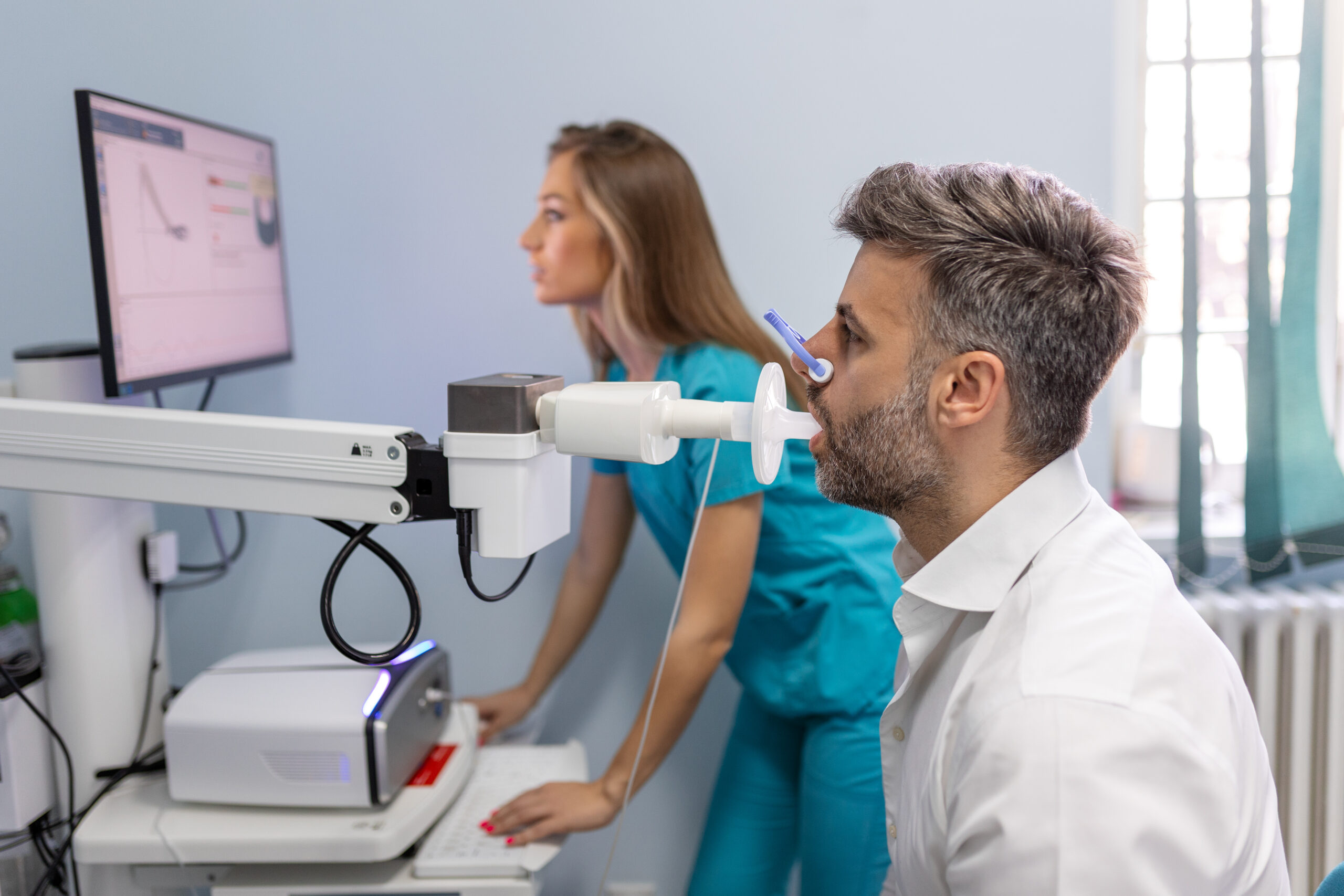 A patient performing spirometry with instruction by his healthcare provider.