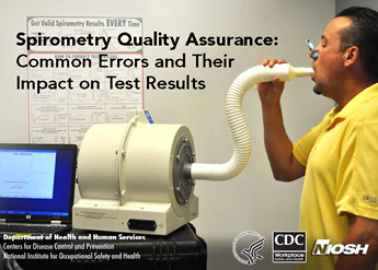 A man performing spirometry through a white hose with a computer screen to the side.