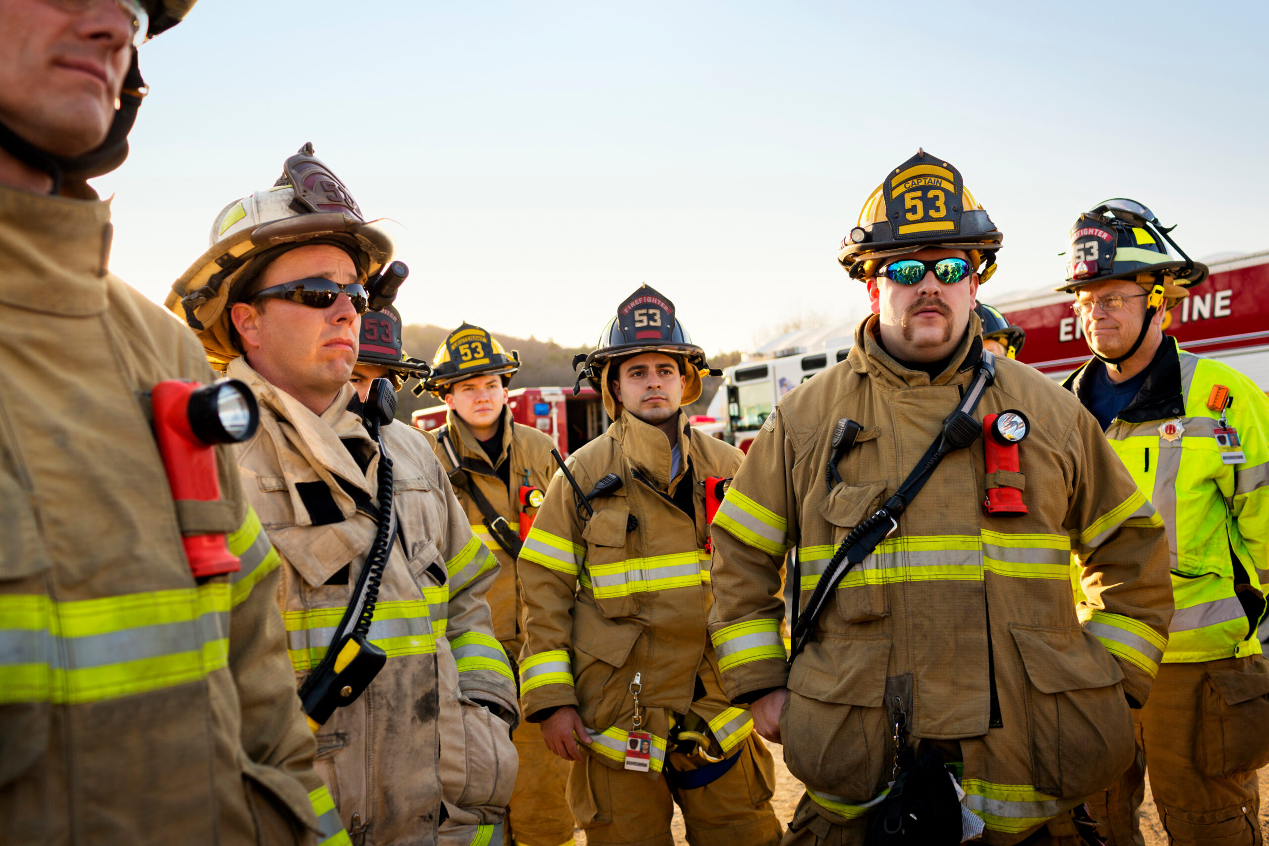 a group of firefighters in turnout gear.