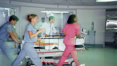 — title missing — Healthcare staff rushing patient on gurney.