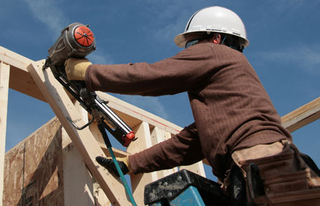 Worker using nail gun