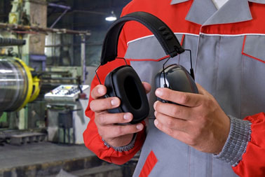 Image showing a factory worker holding a pair of earmuff