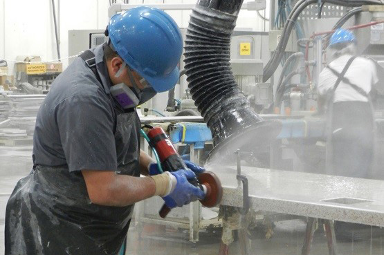 worker cutting stone